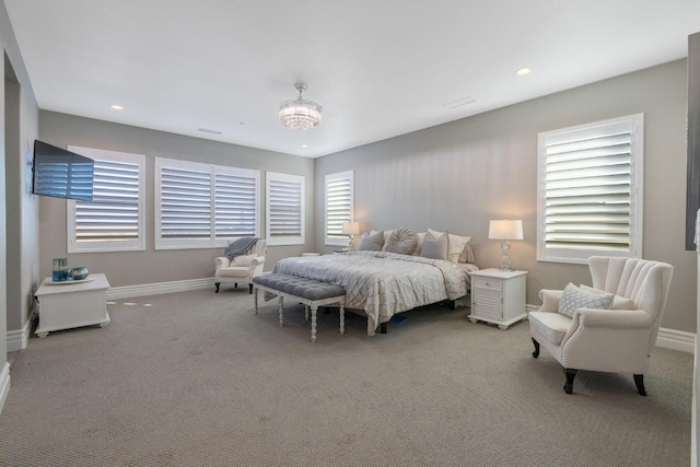 bedroom featuring carpet flooring and a chandelier