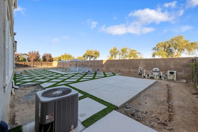 view of yard featuring a patio area and central AC unit