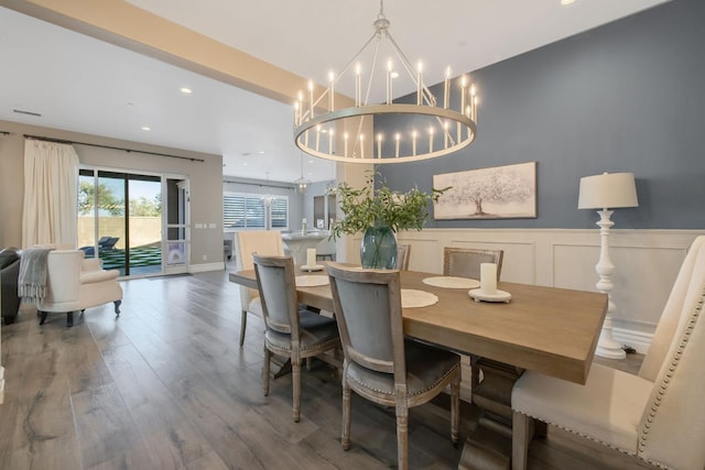 dining room with dark hardwood / wood-style floors and a notable chandelier