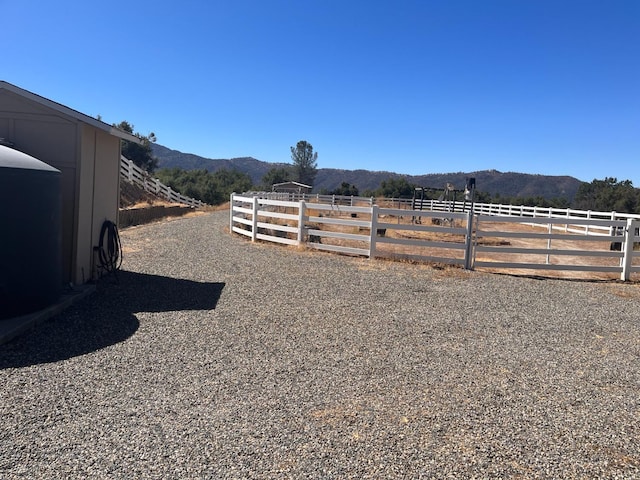 view of yard with a rural view and a mountain view