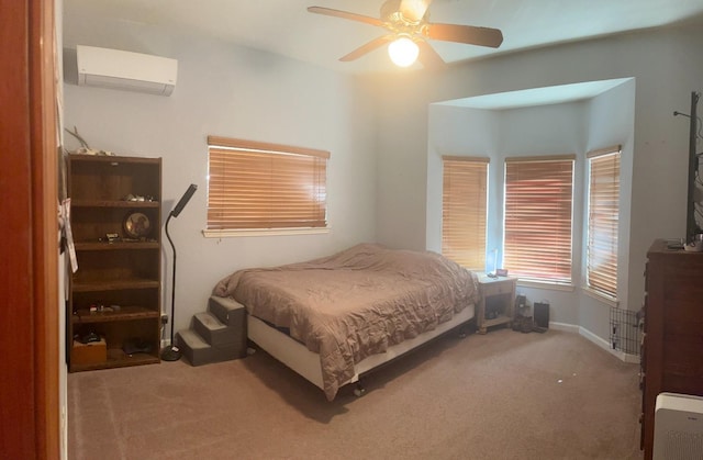 carpeted bedroom featuring ceiling fan and a wall mounted air conditioner