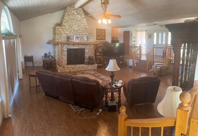 living room featuring wood ceiling, hardwood / wood-style floors, a stone fireplace, lofted ceiling with beams, and ceiling fan