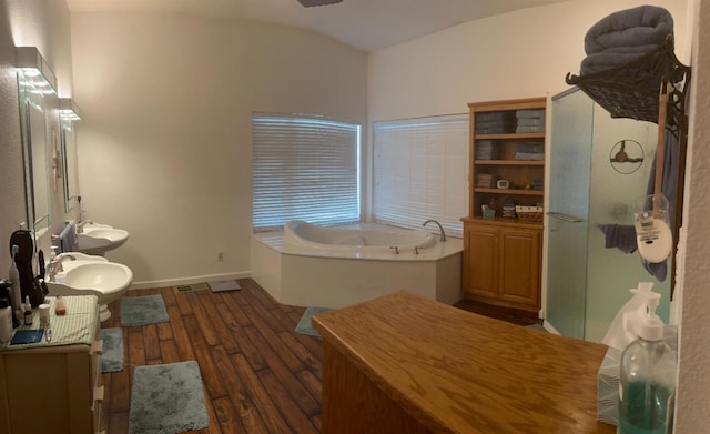 bathroom with sink, wood-type flooring, and plus walk in shower