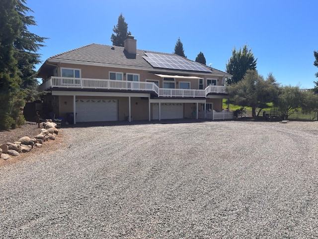 view of property with solar panels and a garage