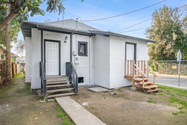 exterior space featuring fence and stucco siding