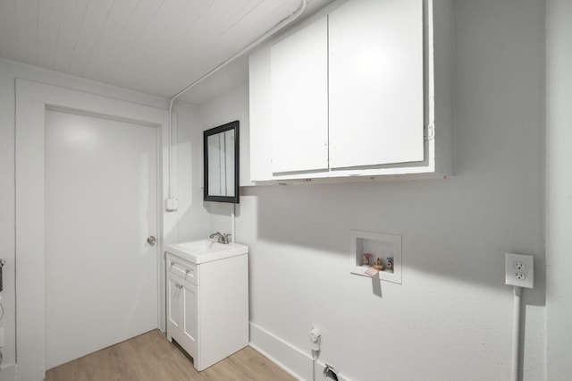 laundry room featuring wooden ceiling, washer hookup, a sink, light wood-style floors, and cabinet space