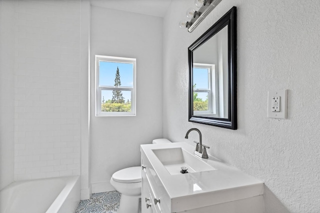 bathroom with tile patterned flooring, vanity, a healthy amount of sunlight, and toilet