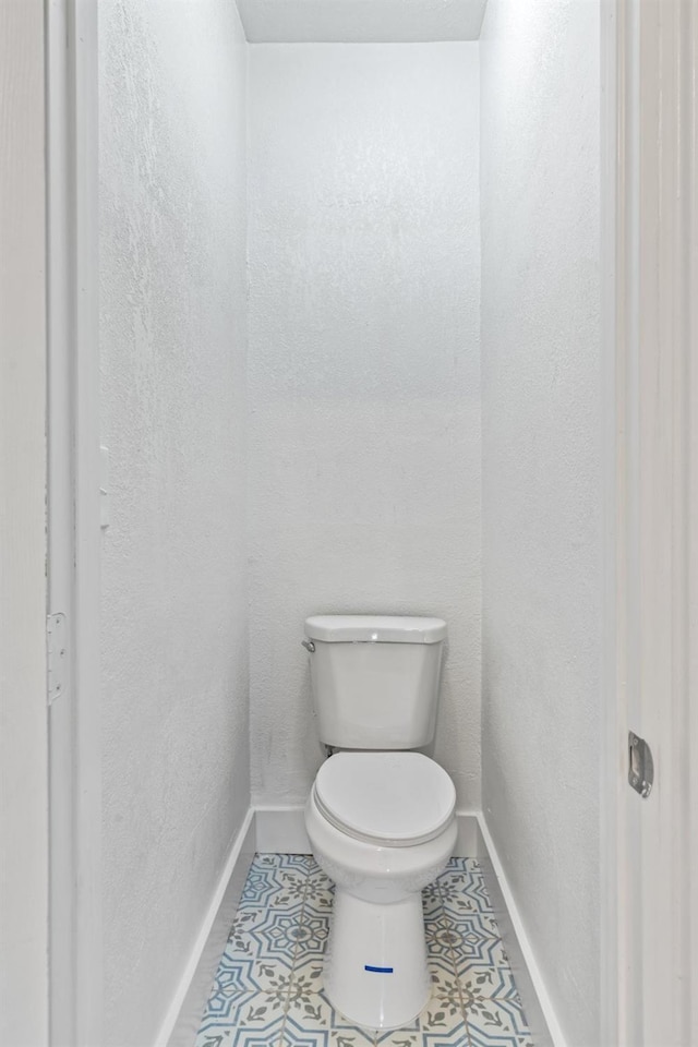 bathroom with tile patterned flooring and toilet