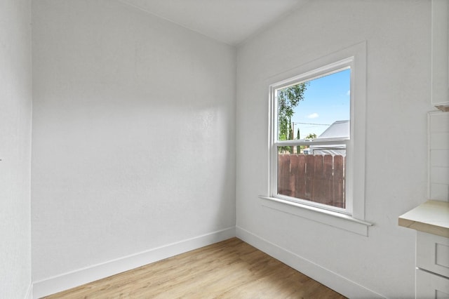 empty room with light hardwood / wood-style flooring