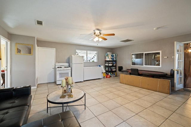 living room featuring light tile patterned flooring and ceiling fan