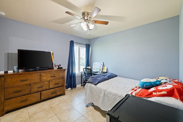 tiled bedroom with ceiling fan and a textured ceiling