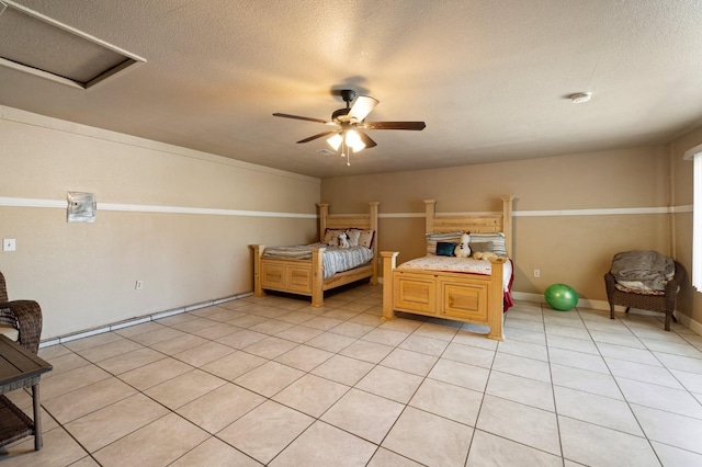 bedroom with ceiling fan, light tile patterned floors, and a textured ceiling