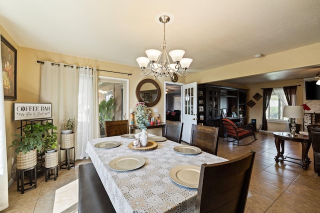 tiled dining area with a chandelier