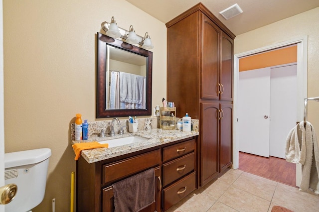 bathroom with tile patterned floors, vanity, and toilet