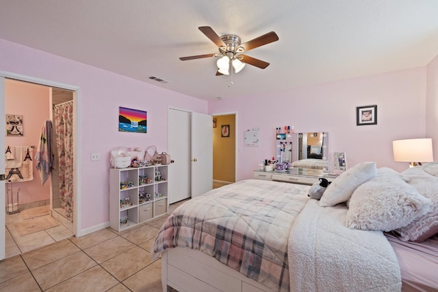 bedroom featuring ceiling fan, a closet, and light tile patterned floors