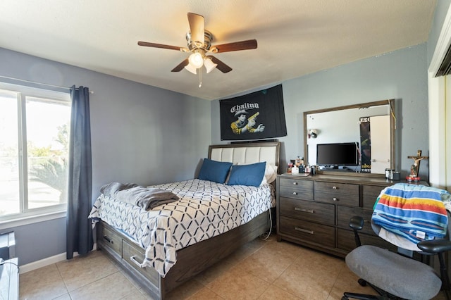 bedroom with ceiling fan and light tile patterned floors