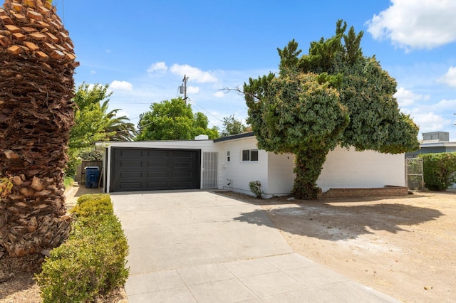 view of front of house with concrete driveway and an attached garage