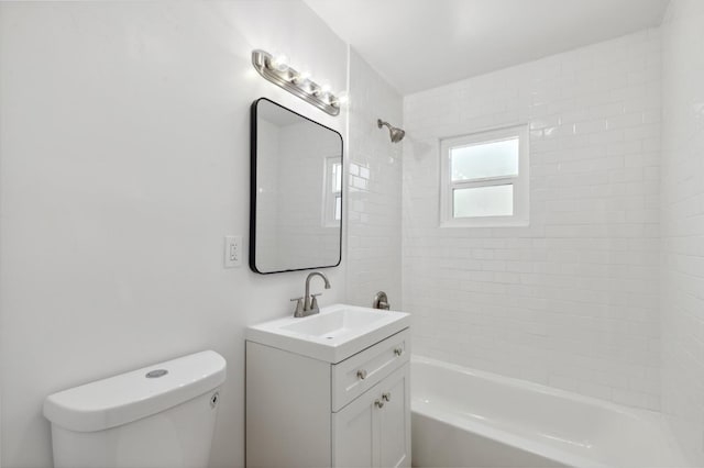 bathroom with tub / shower combination, vanity, and toilet