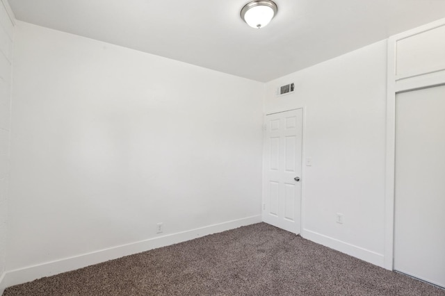 unfurnished bedroom featuring carpet, visible vents, and baseboards