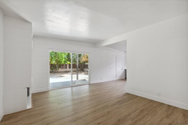 spare room with wood finished floors and baseboards