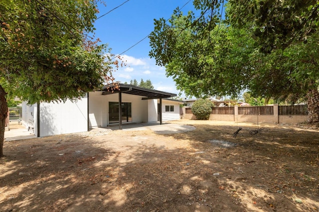 back of property featuring fence