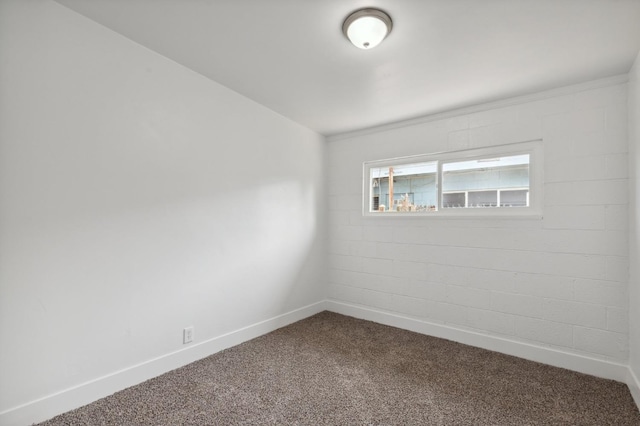 spare room featuring carpet flooring and baseboards