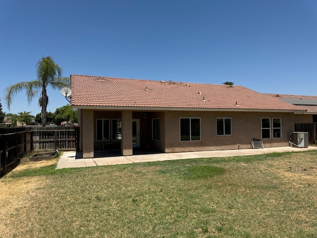 back of house featuring a patio area, central air condition unit, and a lawn