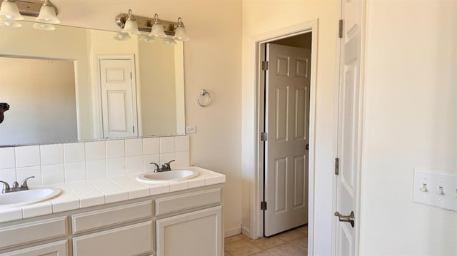 bathroom with tile patterned flooring, decorative backsplash, and vanity