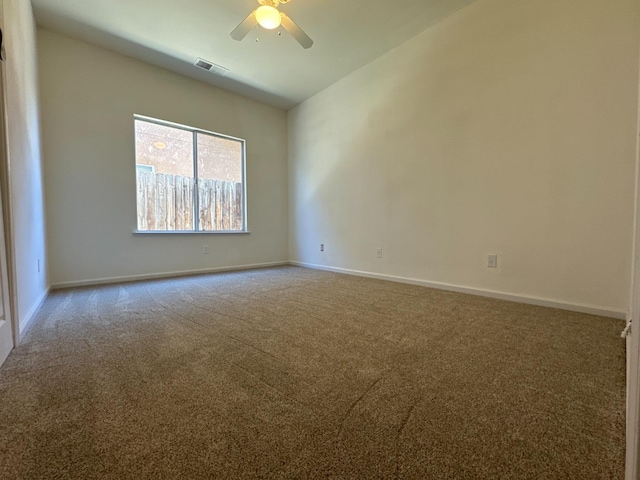 carpeted spare room with ceiling fan