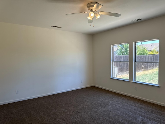 empty room featuring ceiling fan and carpet floors