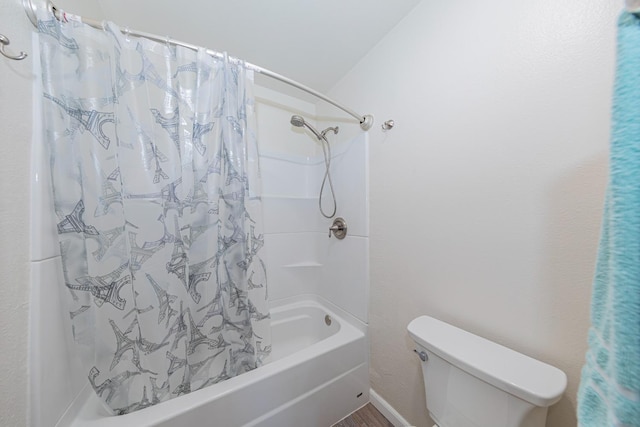 bathroom with shower / bath combo and toilet