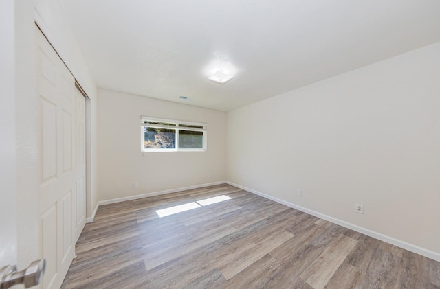 unfurnished room featuring light hardwood / wood-style floors