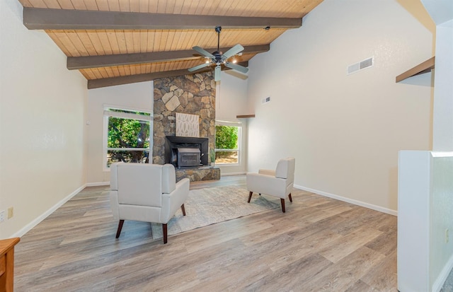 living room with wooden ceiling, ceiling fan, a healthy amount of sunlight, and light wood-type flooring