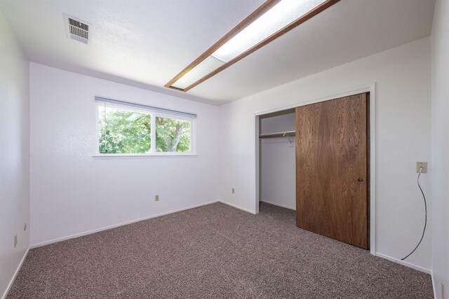 unfurnished bedroom featuring a closet and carpet flooring