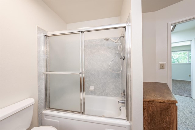 bathroom with bath / shower combo with glass door and toilet