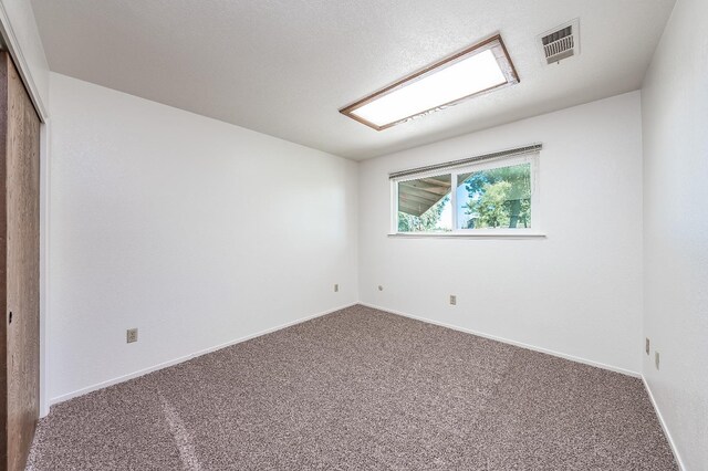 unfurnished room featuring carpet