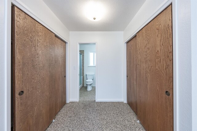 corridor with carpet flooring