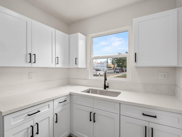 kitchen with white cabinetry and sink