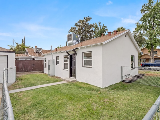 rear view of property featuring a yard