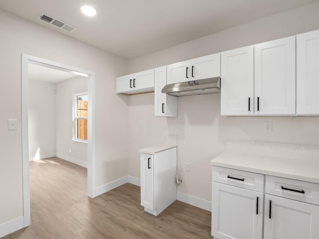 kitchen with white cabinets and light wood-type flooring