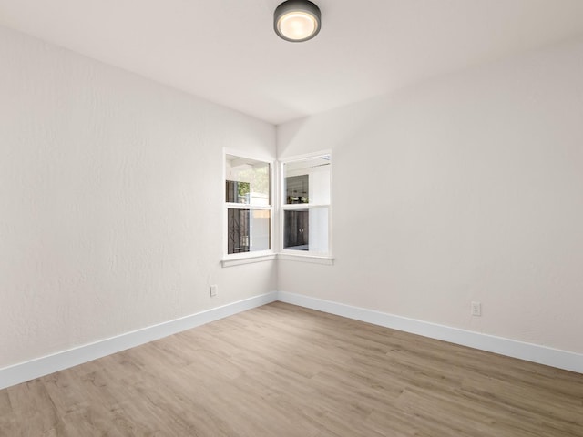 spare room featuring wood-type flooring