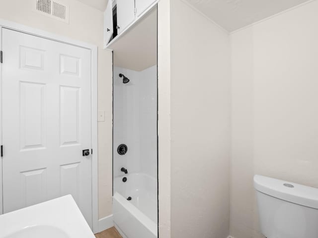 bathroom featuring washtub / shower combination and toilet