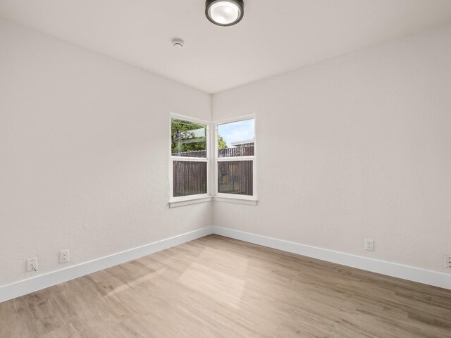 spare room featuring light hardwood / wood-style floors