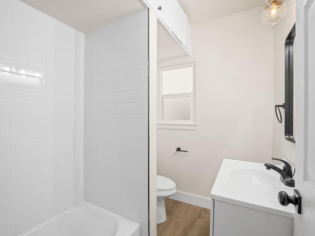 bathroom with toilet, hardwood / wood-style floors, and vanity