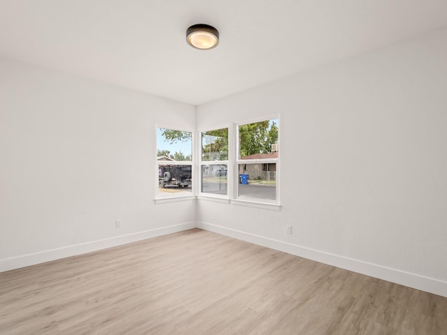 spare room with light hardwood / wood-style flooring