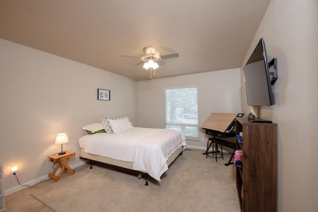 bedroom with light colored carpet, ceiling fan, and baseboards