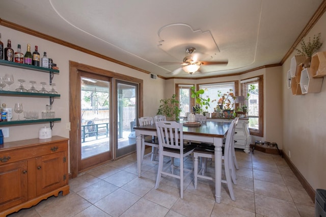 dining area with light tile patterned flooring, visible vents, baseboards, a ceiling fan, and crown molding