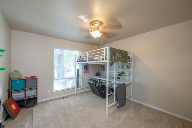 bedroom with a ceiling fan, baseboards, and carpet flooring