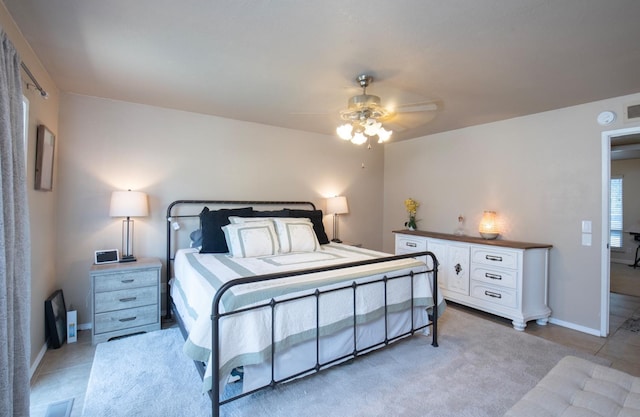 bedroom with baseboards, visible vents, a ceiling fan, and light tile patterned flooring