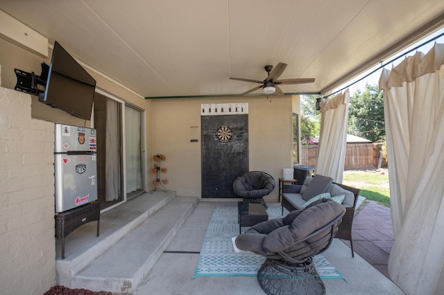 view of patio with fence and a ceiling fan